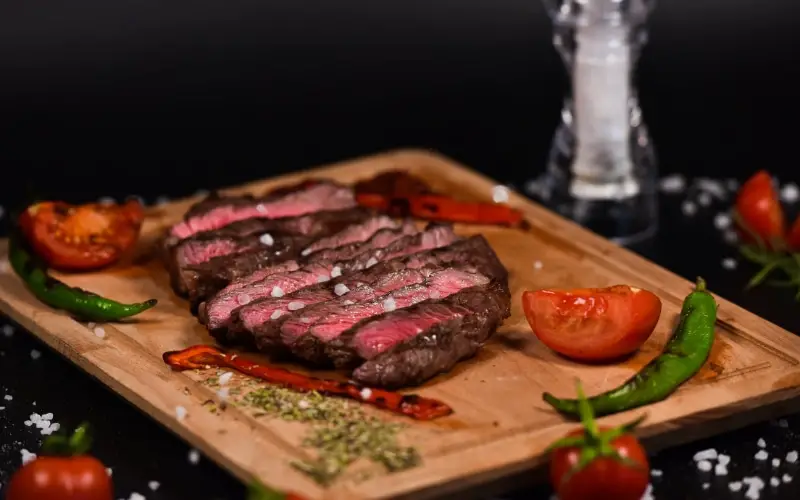 Cutting board with a steak and veggies