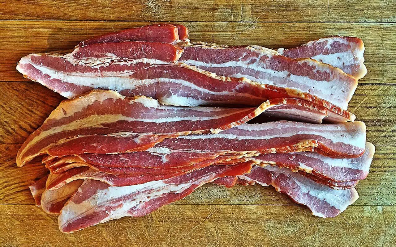 Can you use bacon grease to season Blackstone griddle? - Featured image with uncooked bacon
